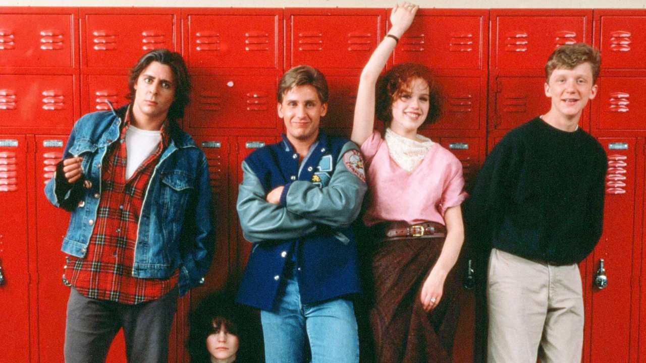 five teens standing against a row of lockers